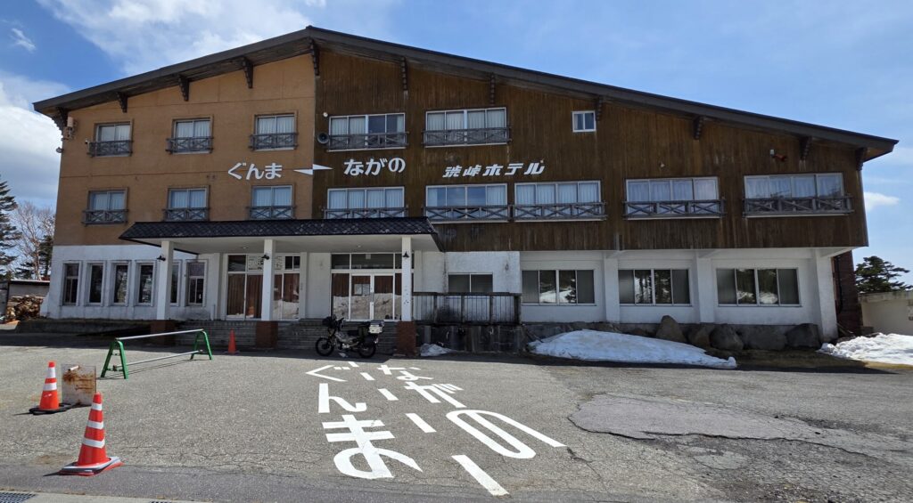 長野県と群馬県にまたがる渋峠ホテルとハンターカブが写った景色