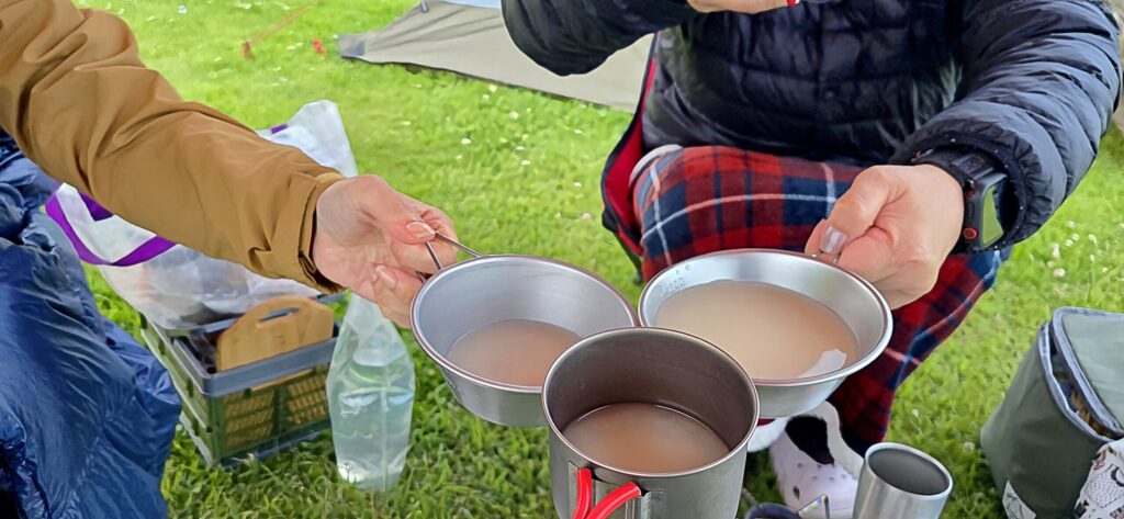 天神岬スポーツ公園でテントを張り、シェラカップで乾杯している様子